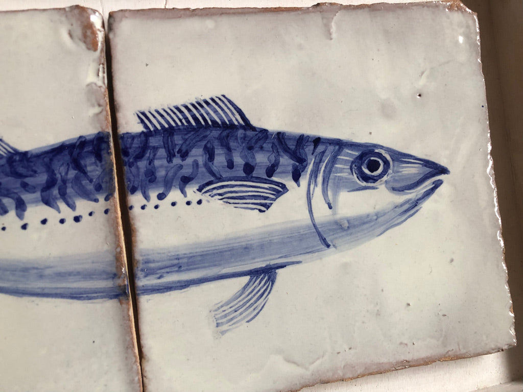 Tile with blue fish illustration on a white background.  Azulejo portuguese. Kézműves fali csempe.