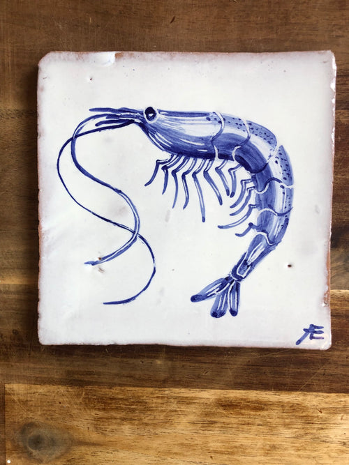 Blue shrimp illustration on a white tile with a wooden background