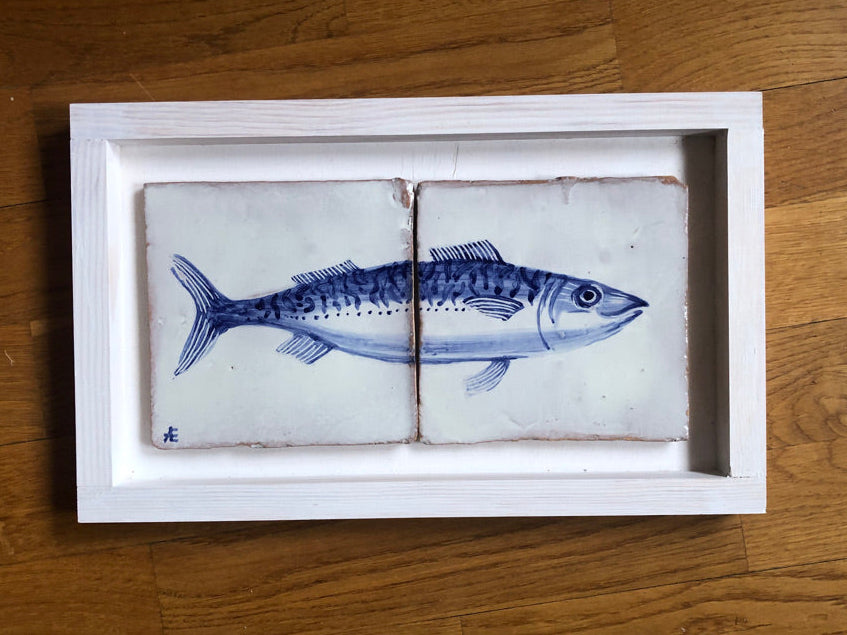 Framed ceramic tiles with a blue fish design on a wooden surface.Azulejo portuguese. Kézműves fali csempe.