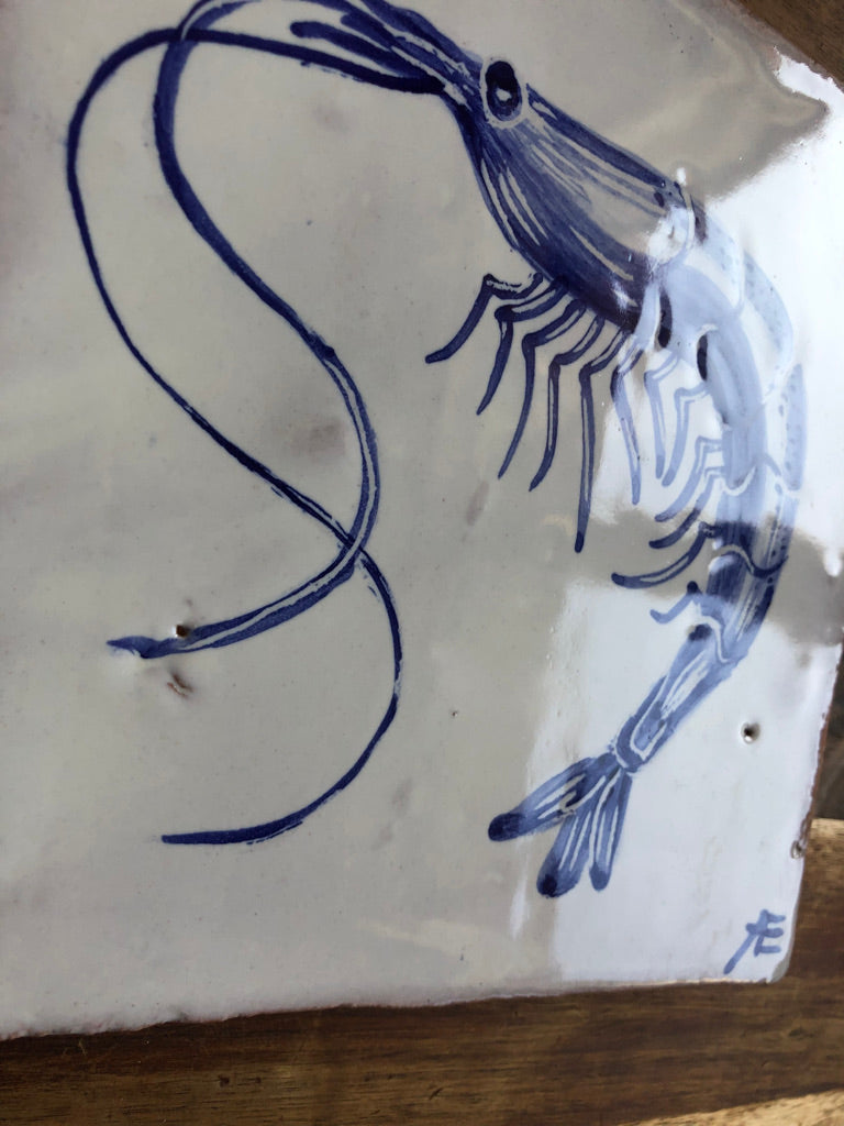 Blue ink drawing of a fish skeleton on a white background. Portuguese azulejo. hanpainted wall tile